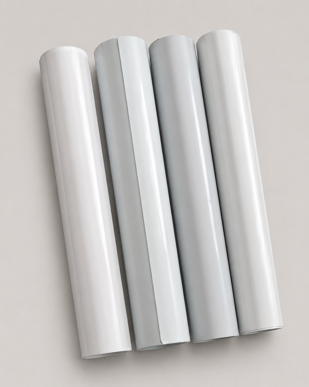 Four one yard rolls of heat transfer vinyl in neutral shades