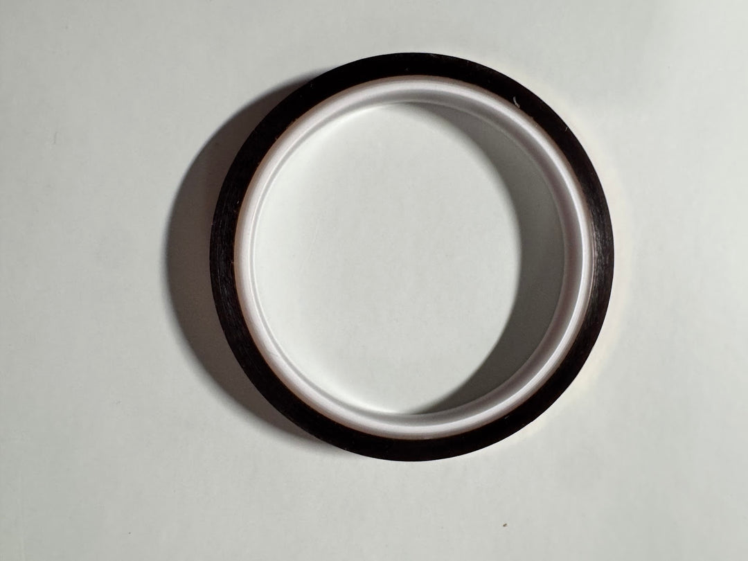 Roll of amber polyimide heat resistant tape on a white core