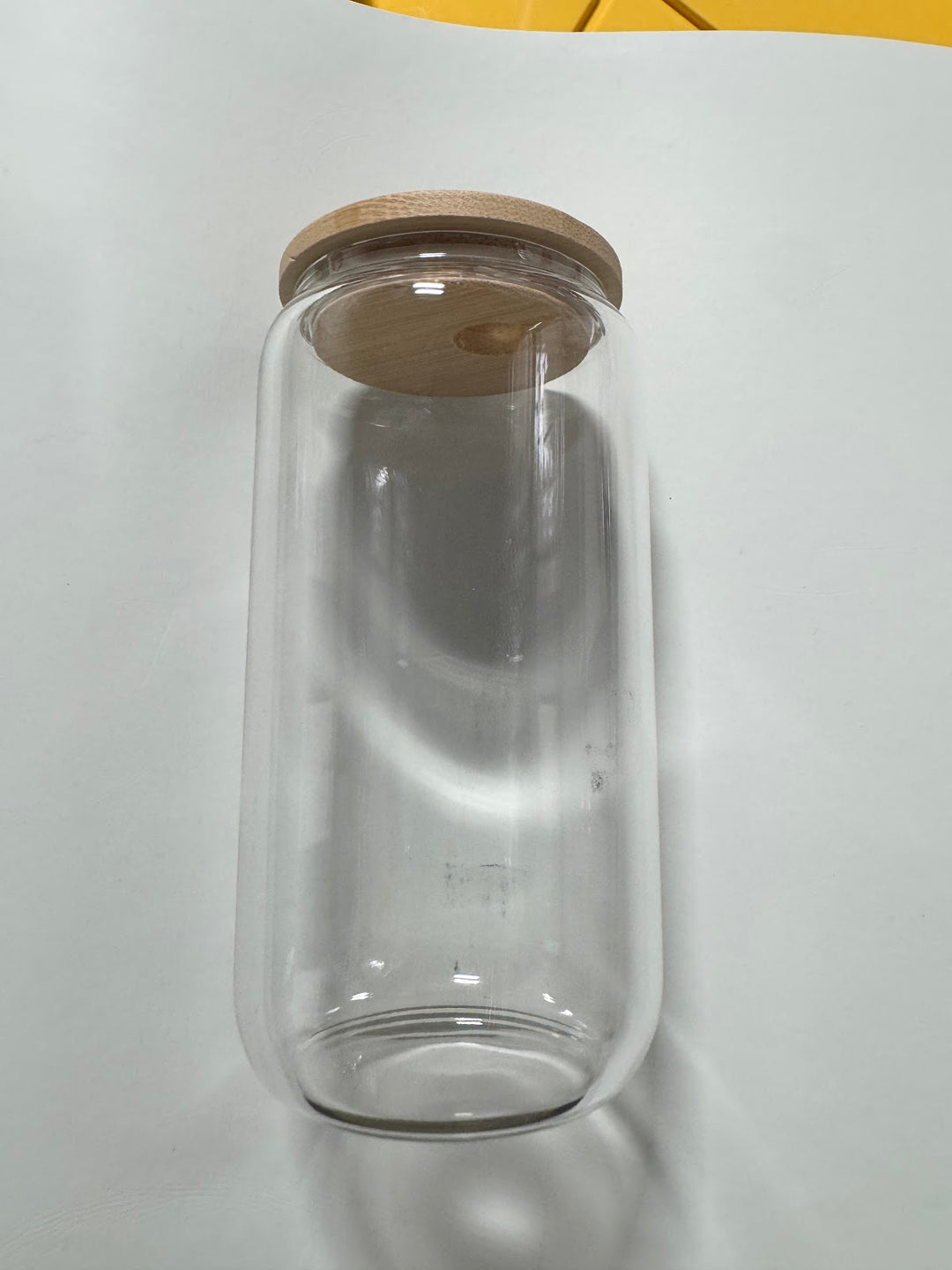 Plain clear glass can tumbler with a bamboo lid