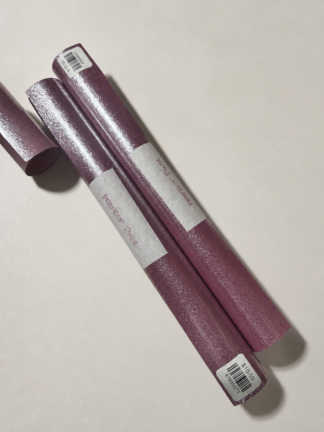 Rolls of Siser Glitter heat transfer vinyl in Perfect Pink, a dusty plum-rose with fine glitter
