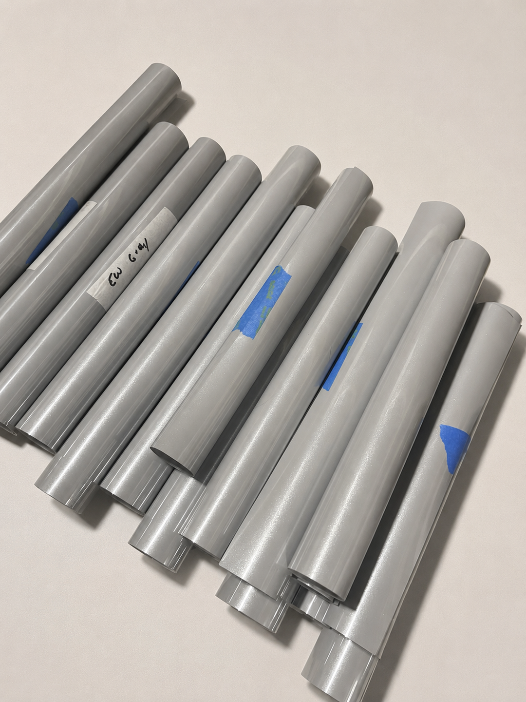 Stacked rolls of Siser EasyWeed heat transfer vinyl in Gray