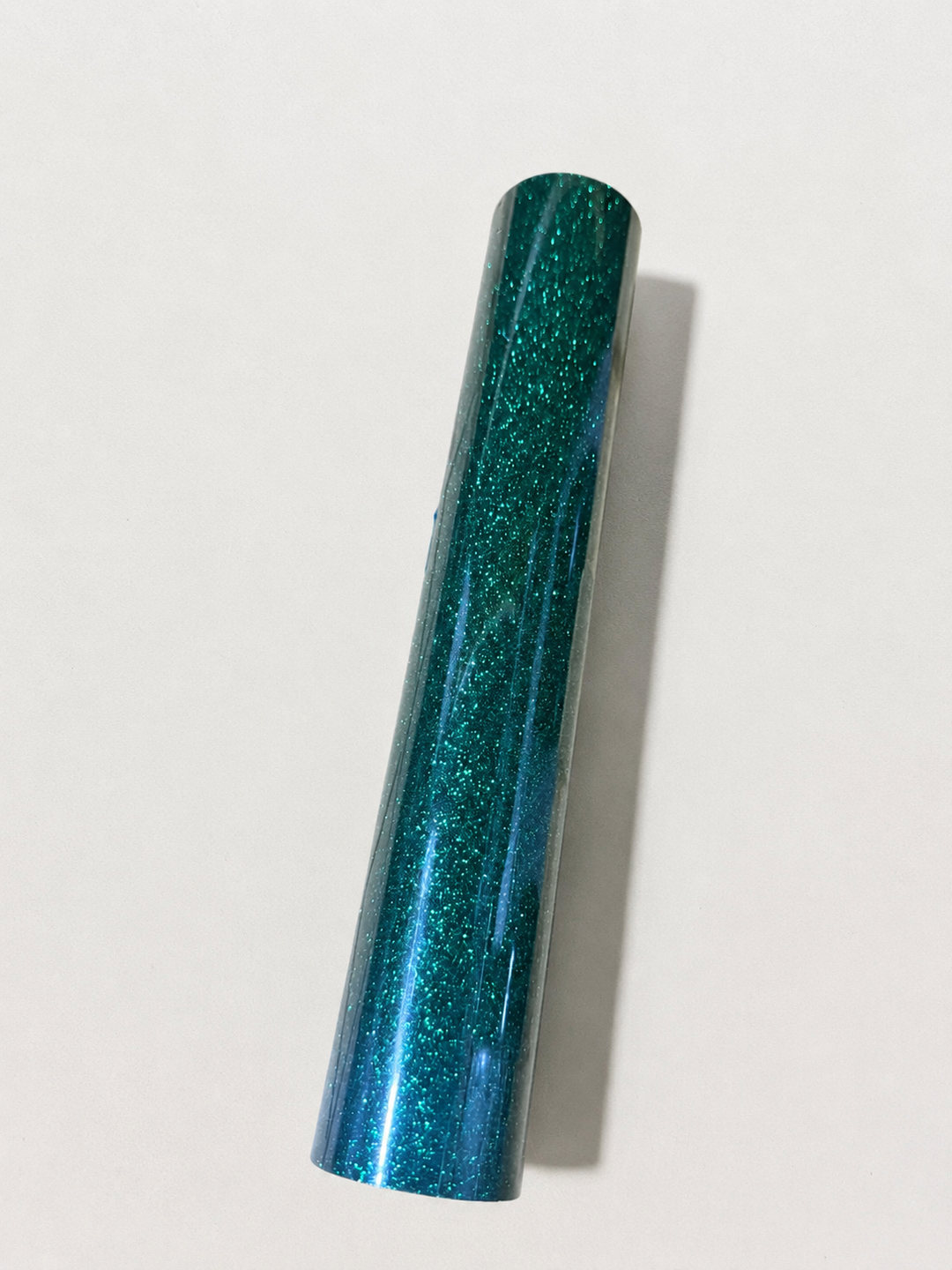 Single roll of Siser Glitter heat transfer vinyl in an emerald teal shade