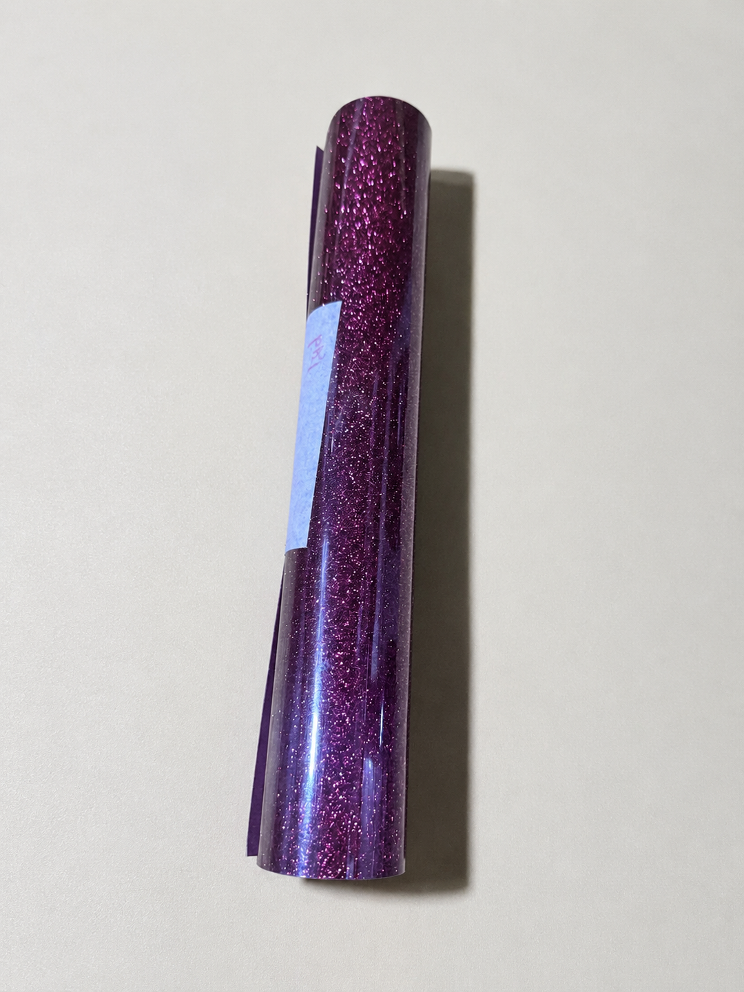 Single roll of Siser Glitter heat transfer vinyl in a magenta shade