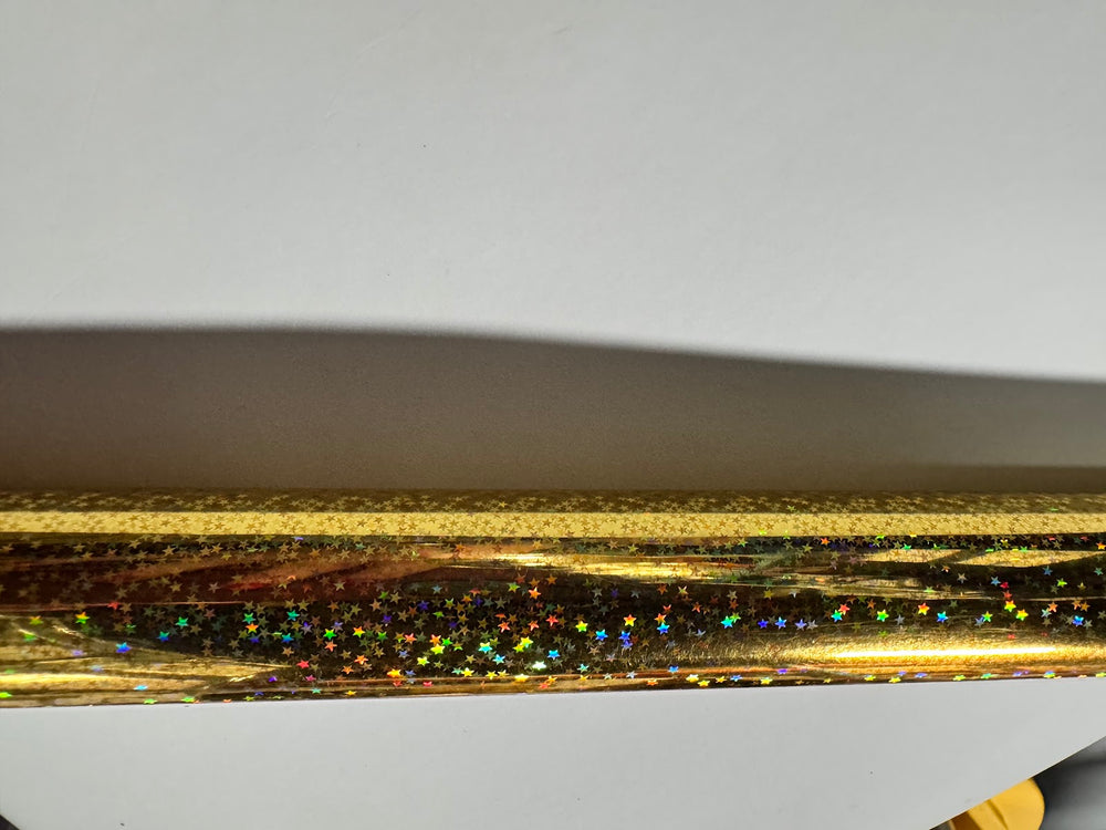 Close view of the gold holographic star foil surface and product code TSX-C GO K162