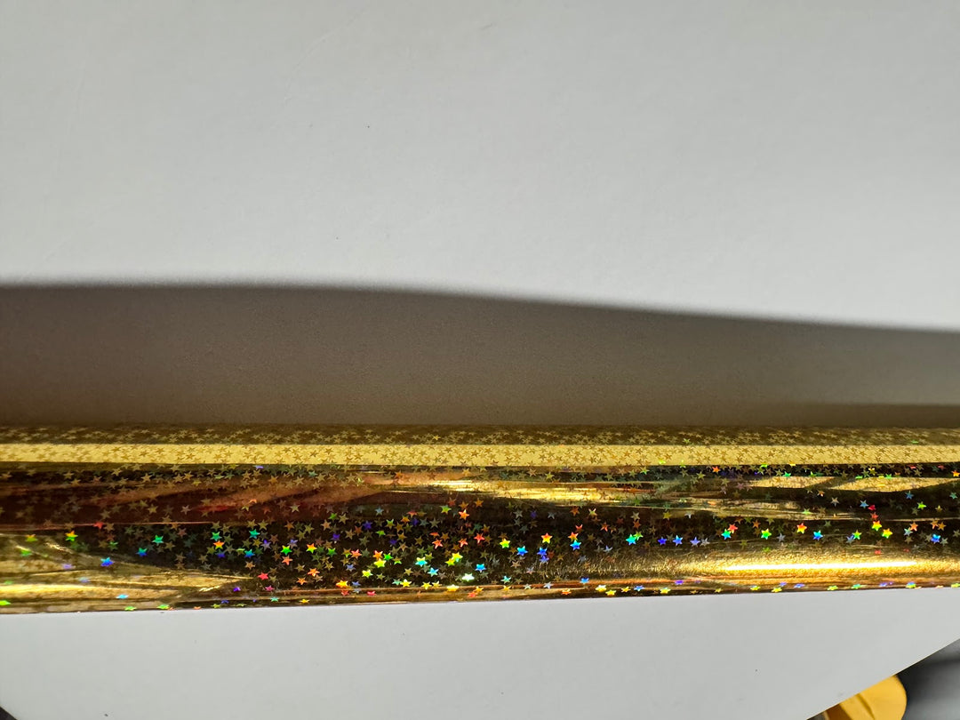 Close view of the gold holographic star foil surface and product code TSX-C GO K162