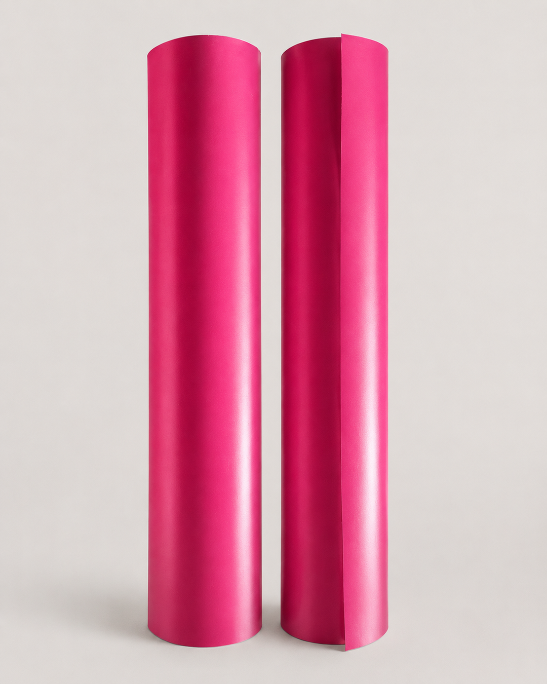 The same two magenta satin heat transfer vinyl rolls from a second angle