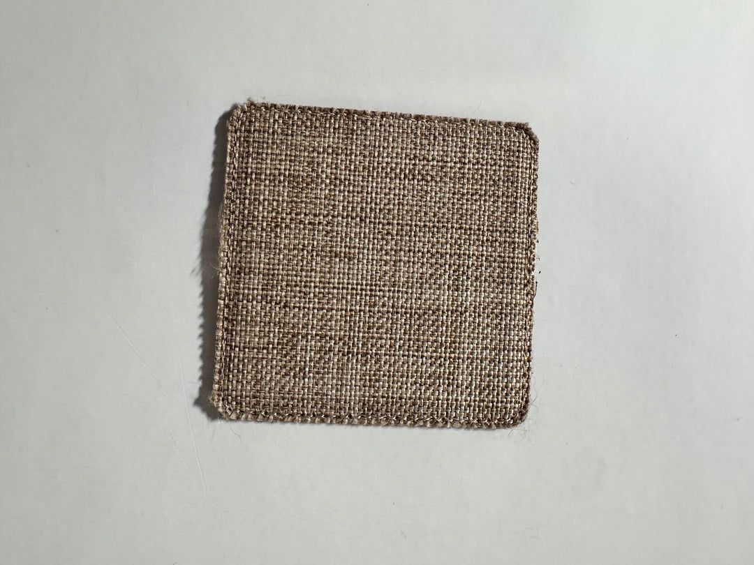 Square burlap coaster blank in natural tan weave with rounded corners and raw fraying edges