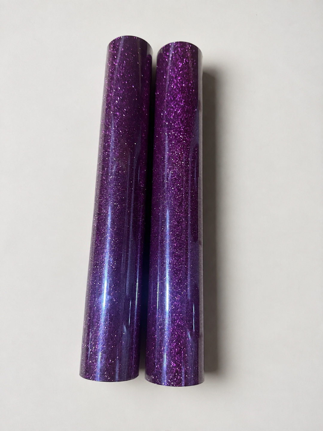 Two rolls of Siser Glitter heat transfer vinyl in a purple shade