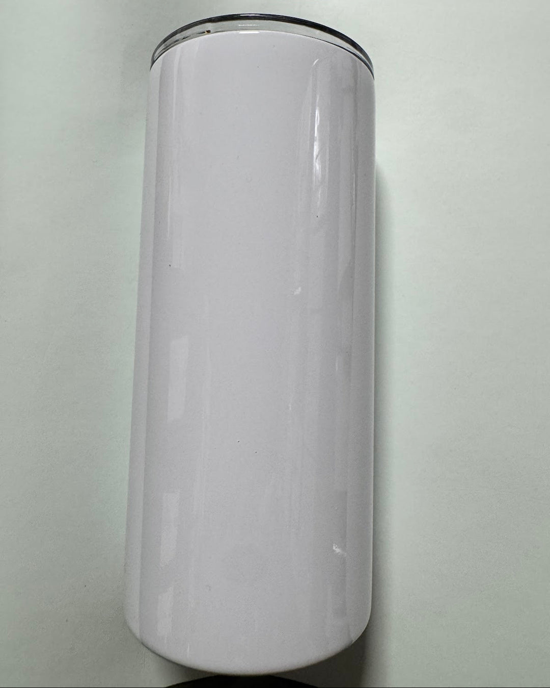 Glossy white sublimation-coated tumbler with a black base rim