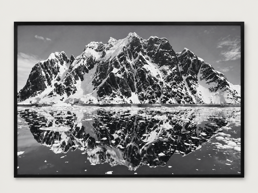 Black and white mountain reflection photograph in a black frame