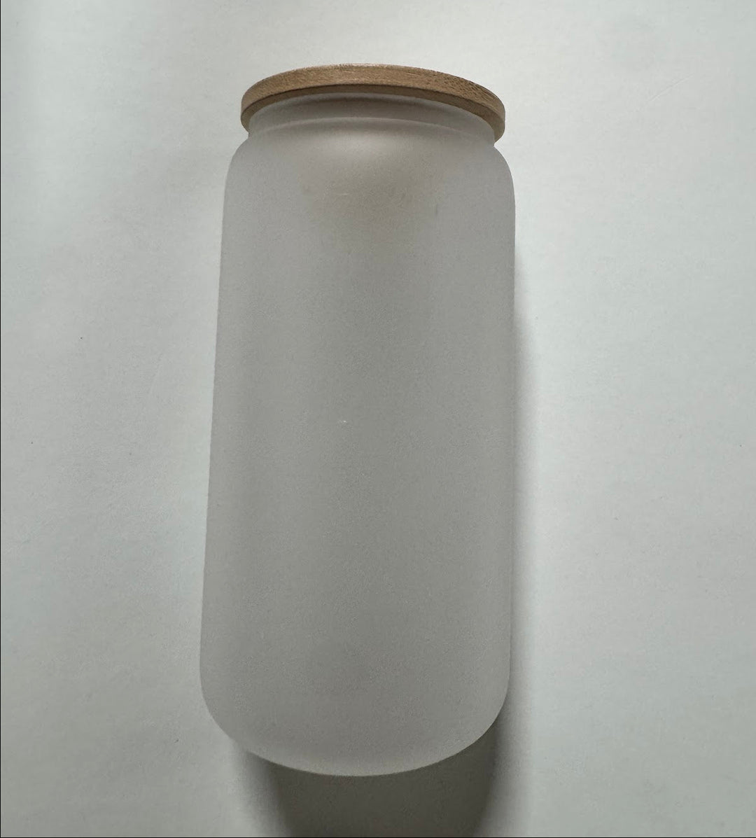 Tall frosted glass water bottle with a screw-on bamboo lid