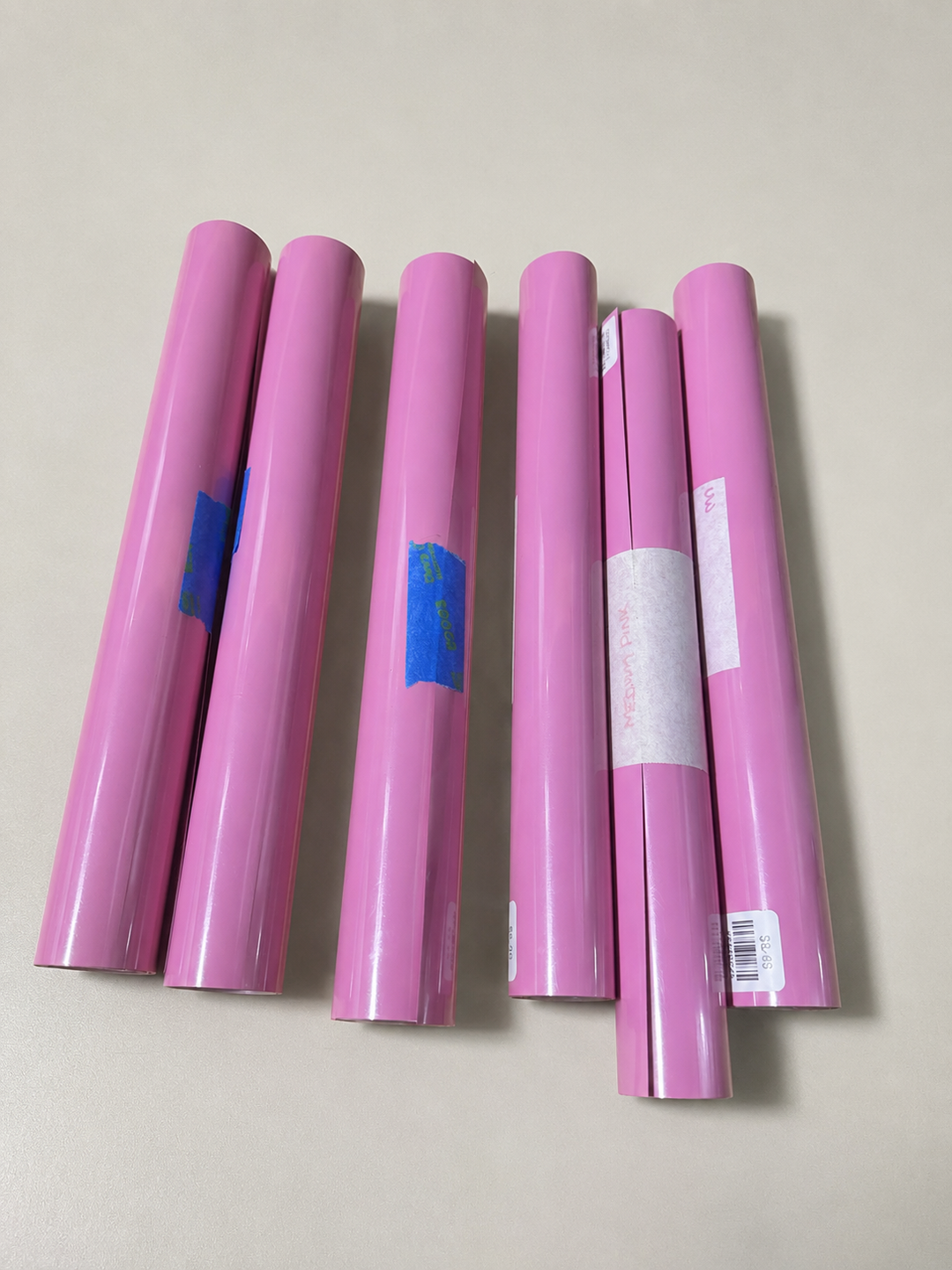 Rolls of Siser EasyWeed heat transfer vinyl in Medium Pink, a bright bubblegum pink
