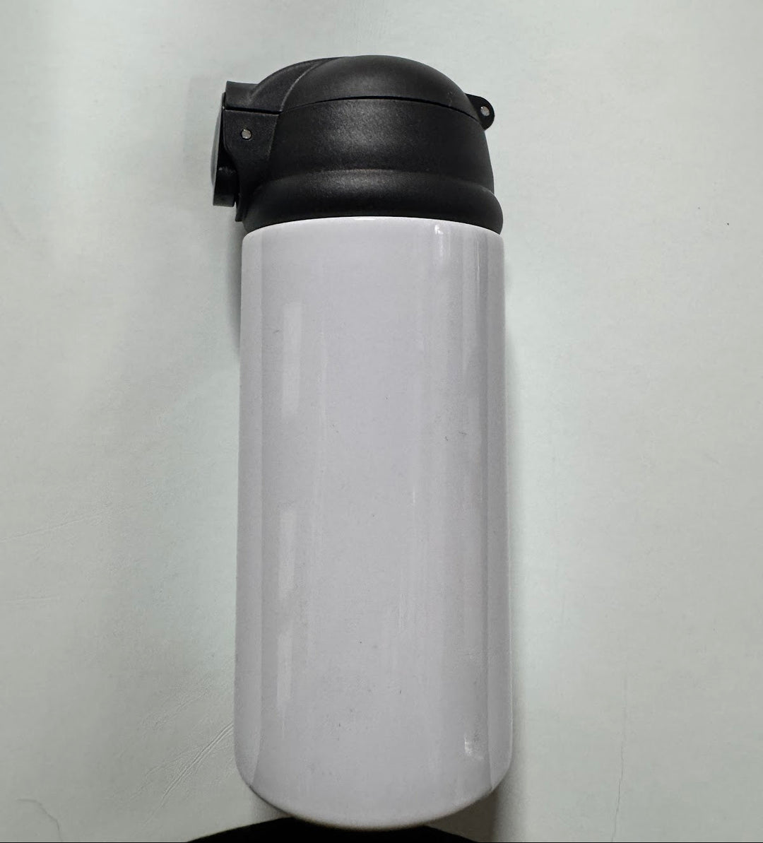 Glossy white sublimation water bottle with a hinged black flip-top lid