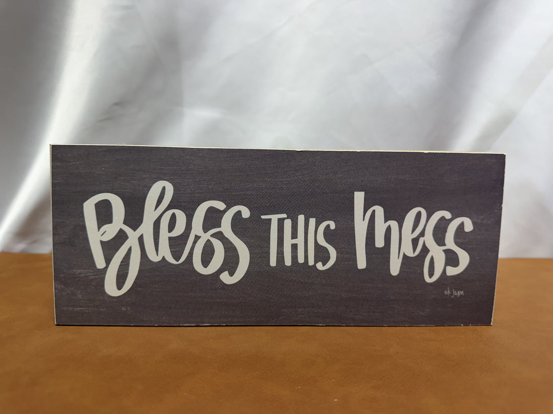 Wood sign reading Bless This Mess