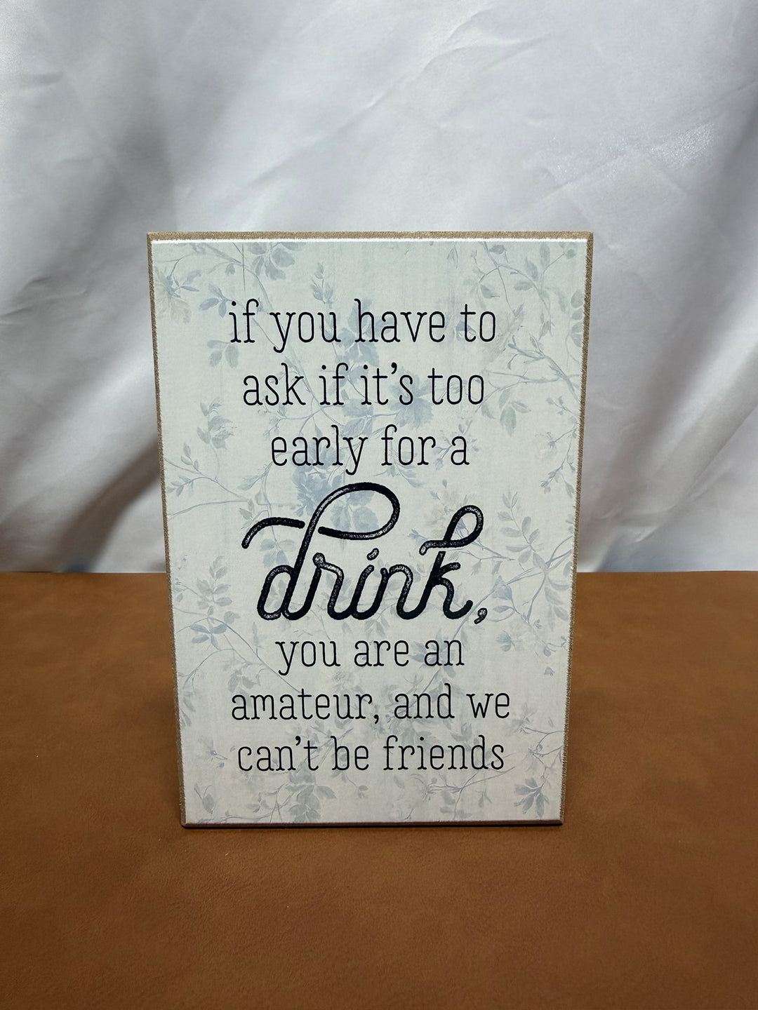 Floral wood sign joking about being a drinking amateur