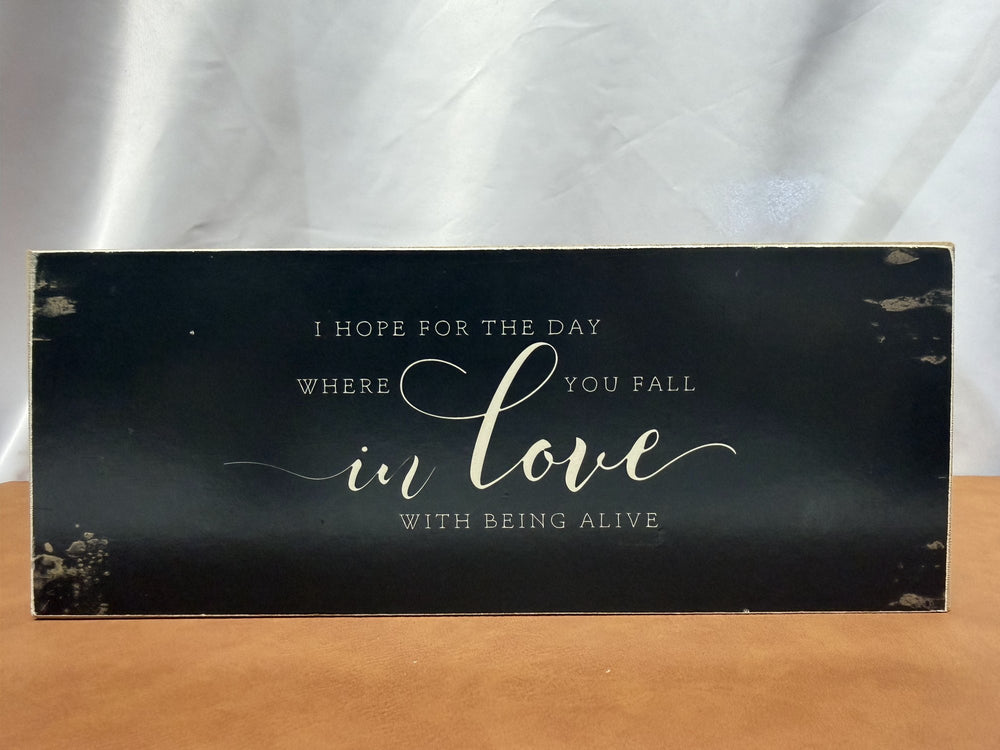 Wood sign reading I hope for the day where you fall in love with being alive