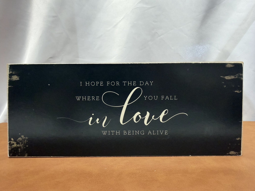 Wood sign reading I hope for the day where you fall in love with being alive