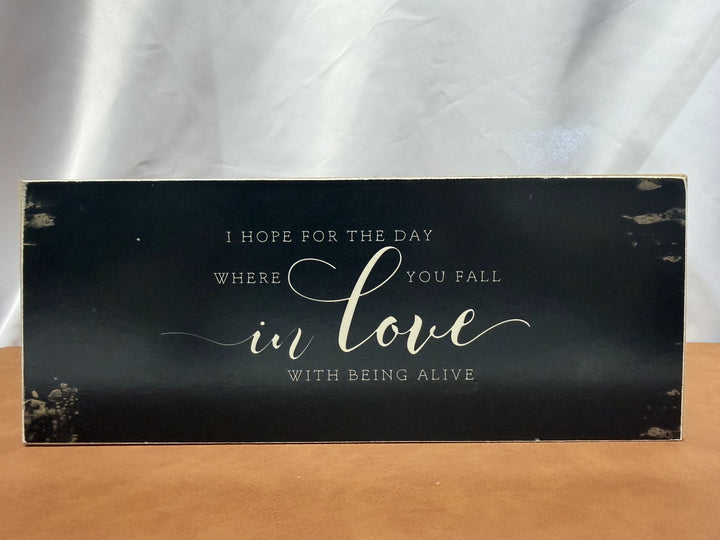 Wood sign reading I hope for the day where you fall in love with being alive
