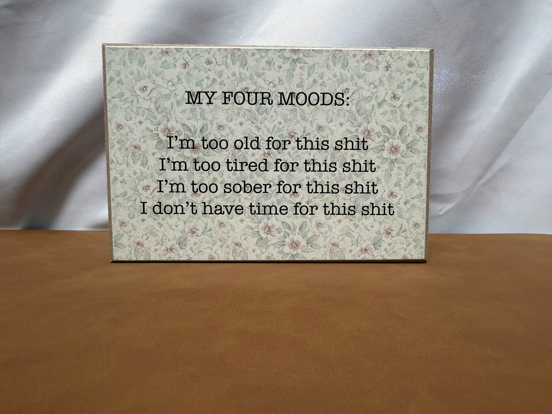 Floral wood sign listing four sarcastic moods