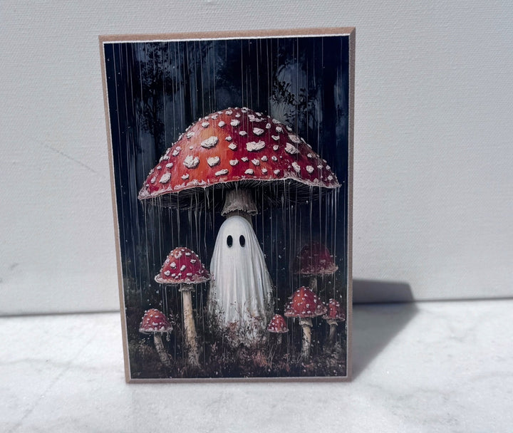 Ghost standing beneath a giant toadstool mushroom canvas print