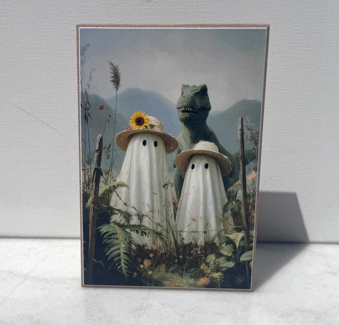 Two ghosts in sunhats standing with a dinosaur canvas print