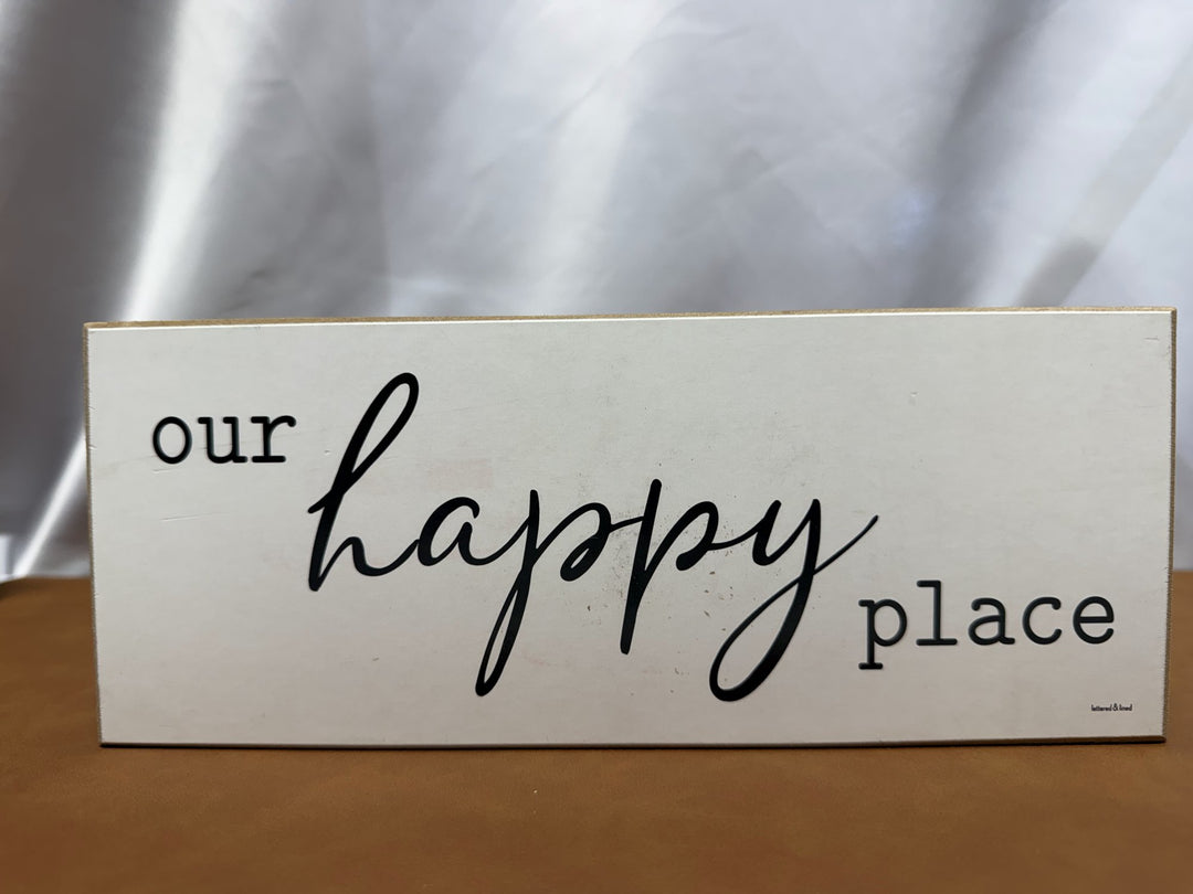 Wood sign reading Our Happy Place