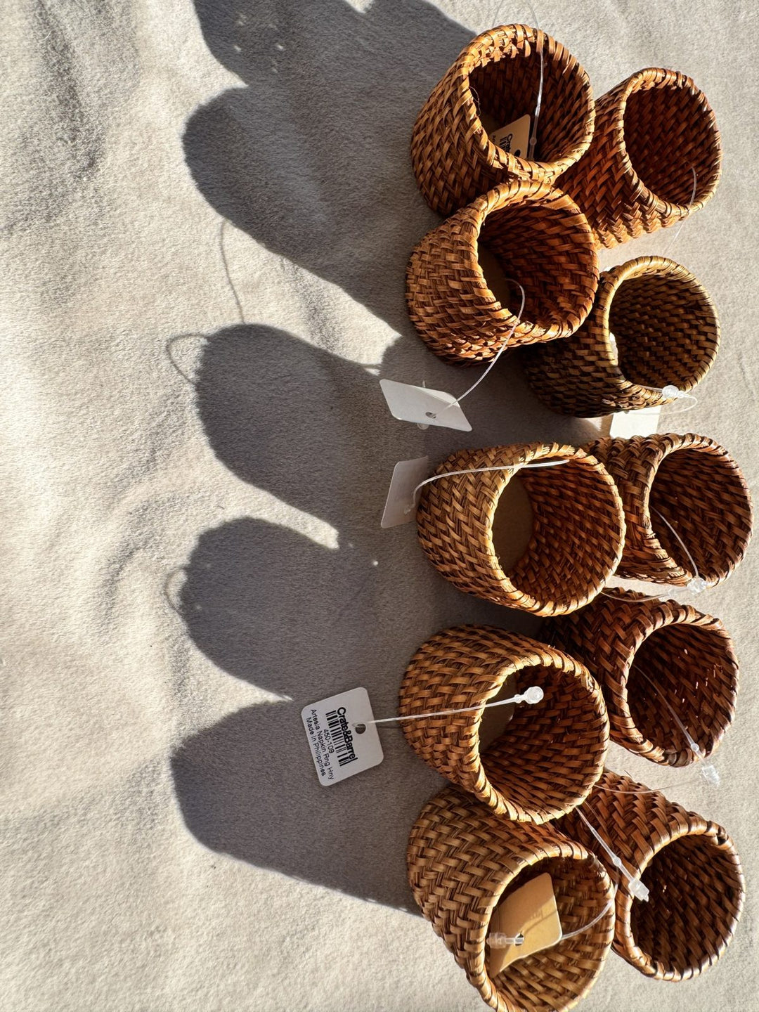 Lot 23 – Crate & Barrel Artesia Honey Rattan Napkin Rings, Set of 8
