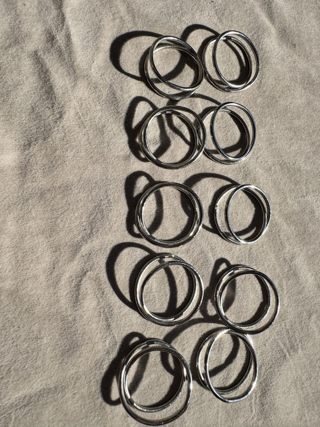 Lot 25 – Silver Twisted Loop Napkin Rings, Set of 10