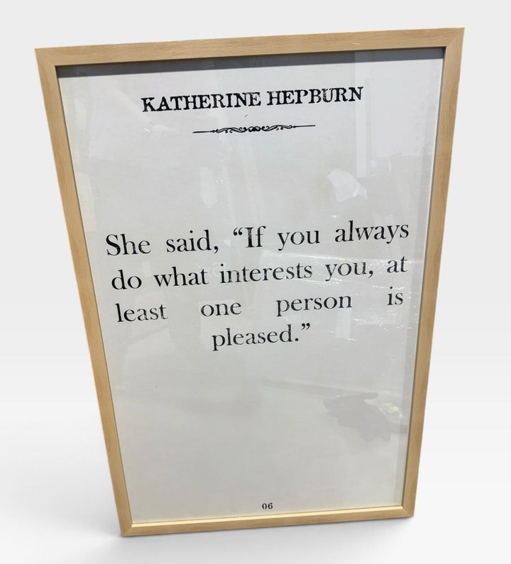 A framed quote print featuring a quote by Katherine Heyburn, displayed in a light wood frame against a clean white background.