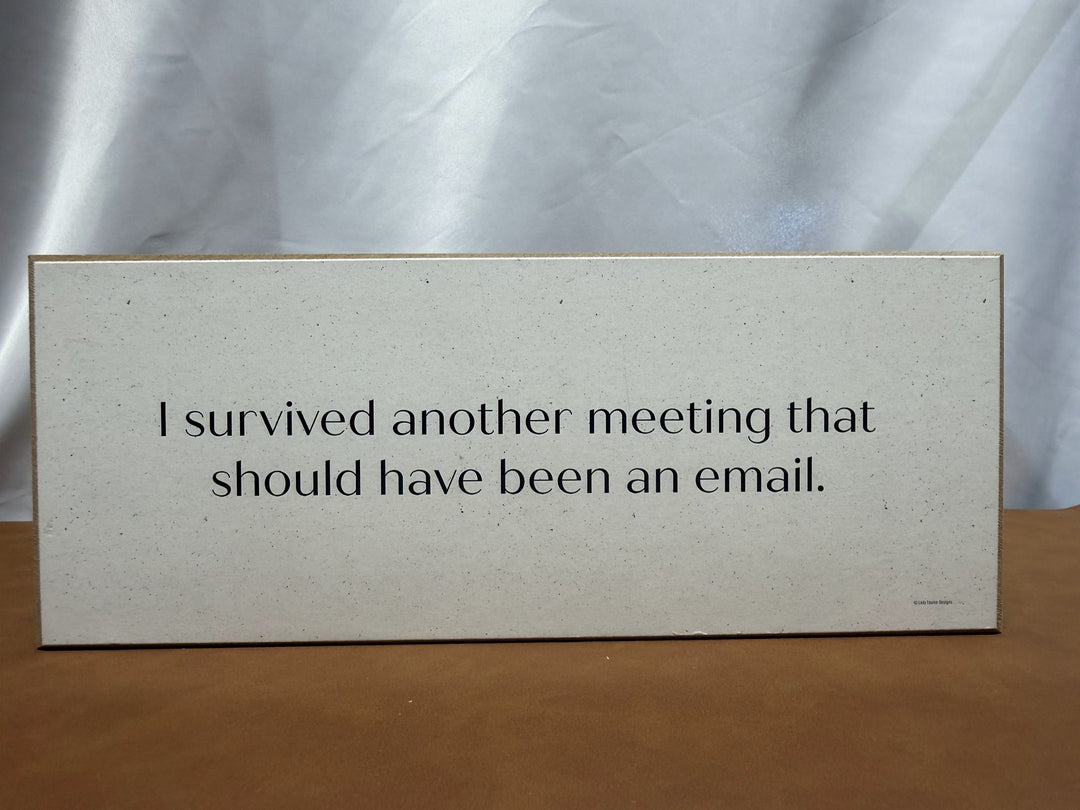 Wood sign about surviving a meeting that should have been an email
