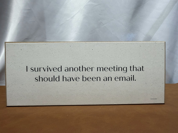 Wood sign about surviving a meeting that should have been an email