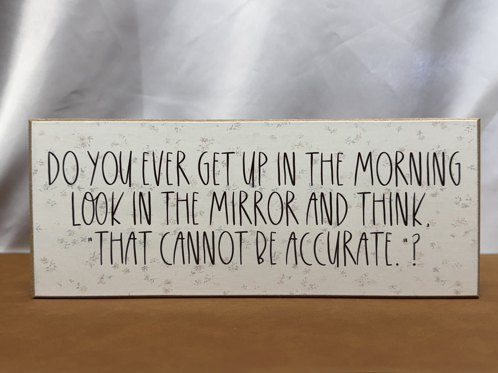 Floral wood sign about the mirror not being accurate