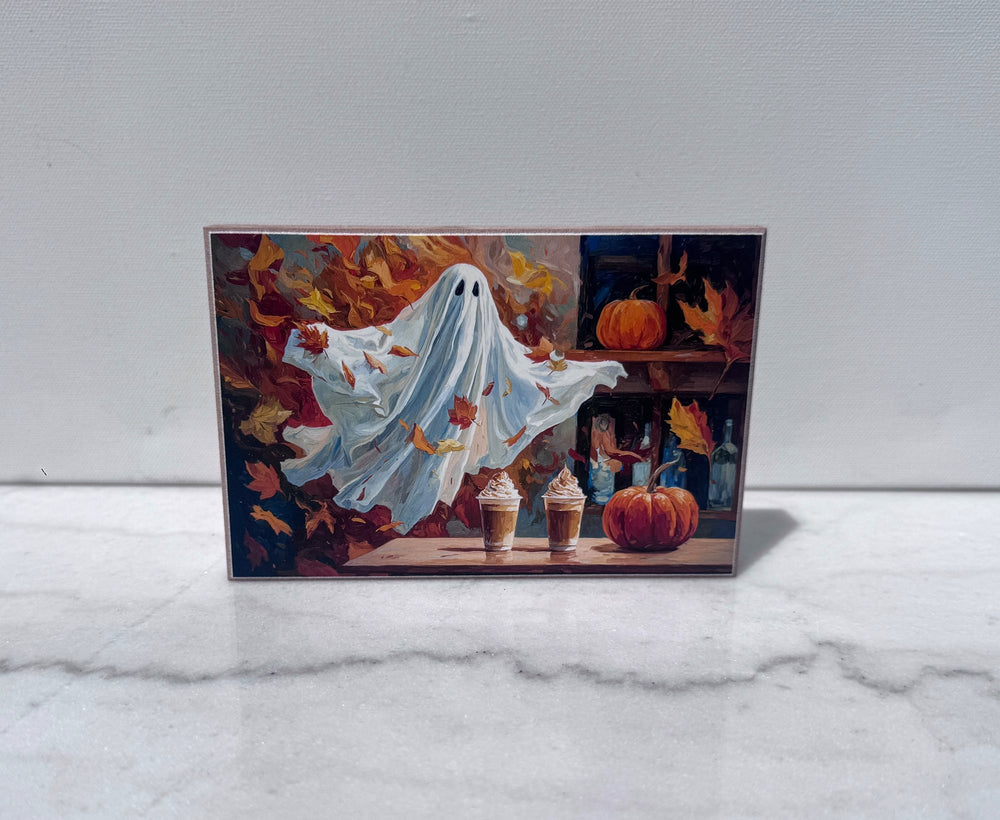 Ghost holding pumpkin spice lattes among fall leaves canvas print