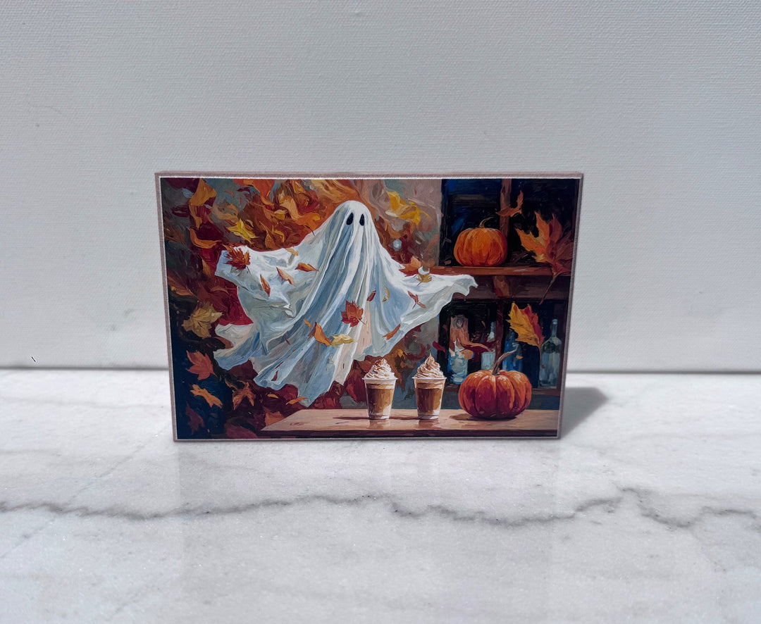 Ghost holding pumpkin spice lattes among fall leaves canvas print