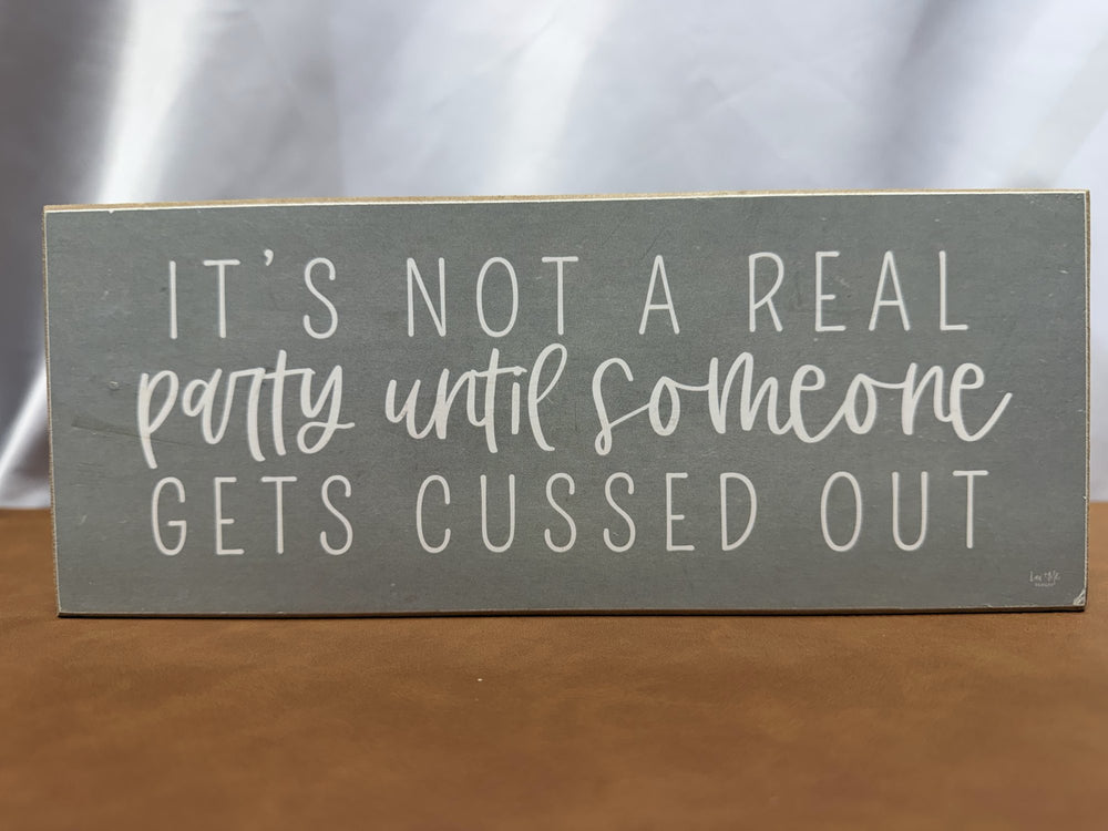 Wood sign joking about parties and getting cussed out