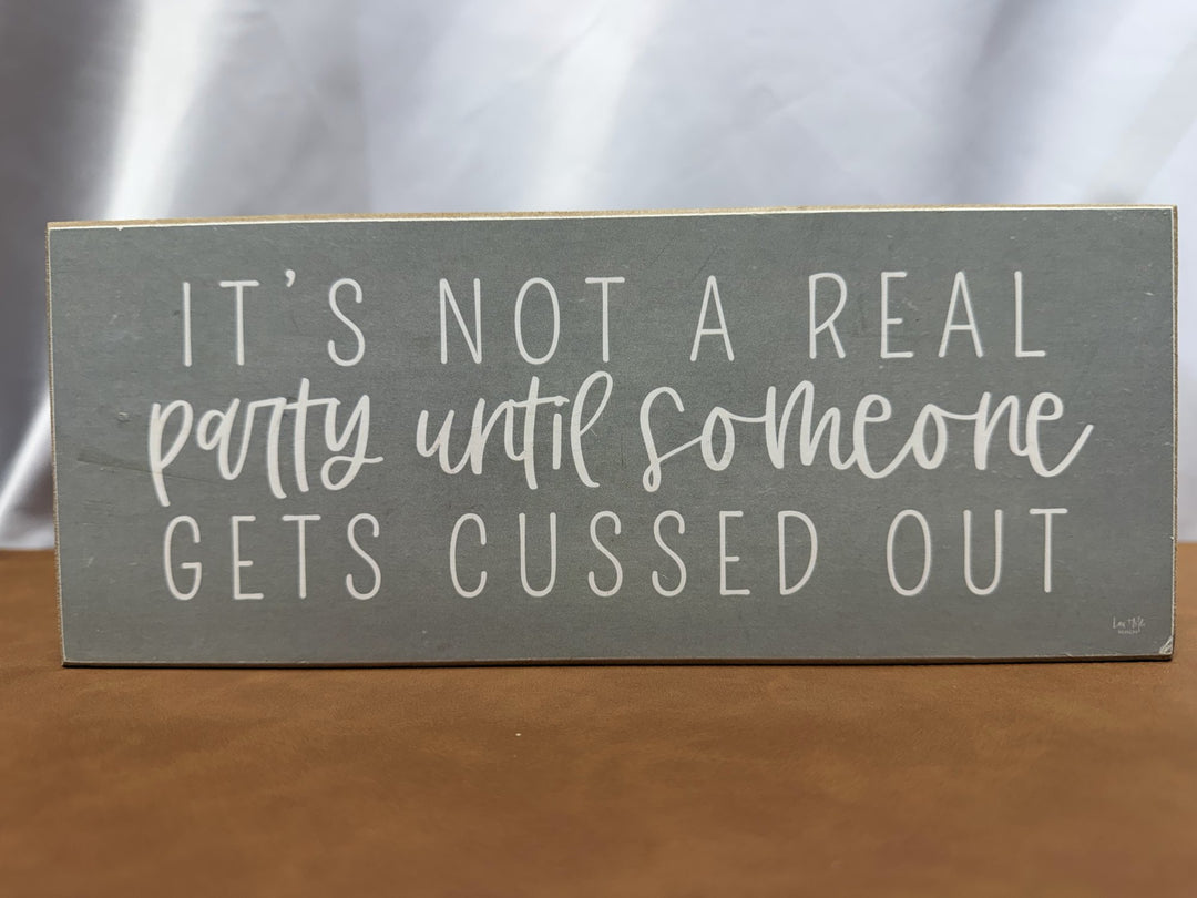 Wood sign joking about parties and getting cussed out