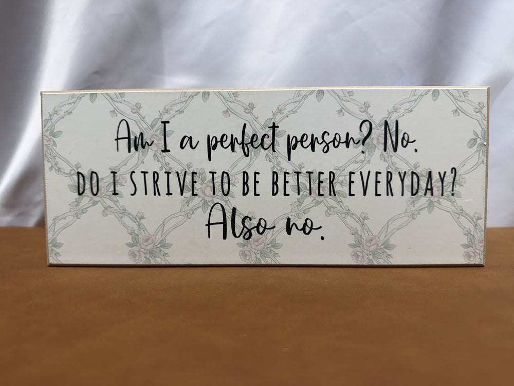 Floral wood sign joking about not being a perfect person