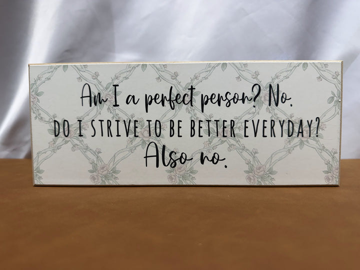 Floral wood sign joking about not being a perfect person