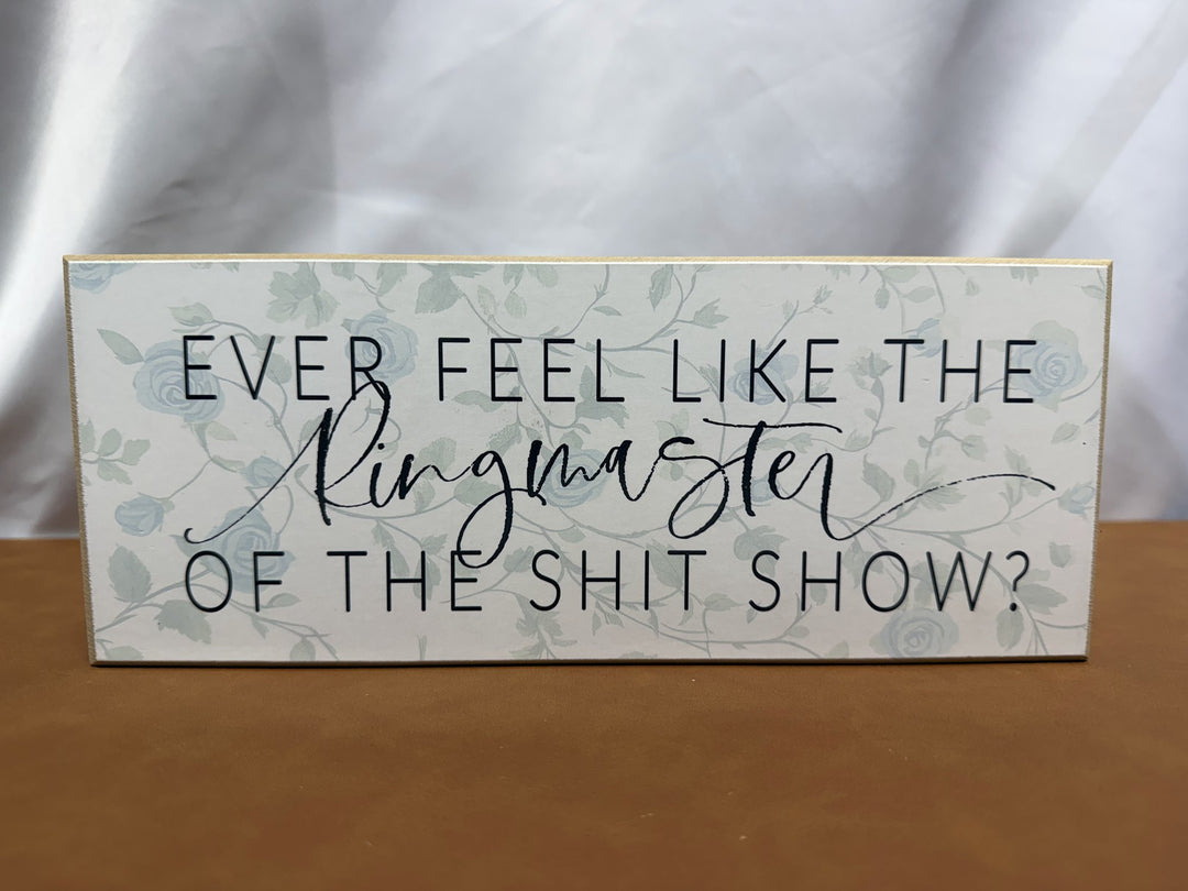 Floral wood sign joking about being the ringmaster of the chaos