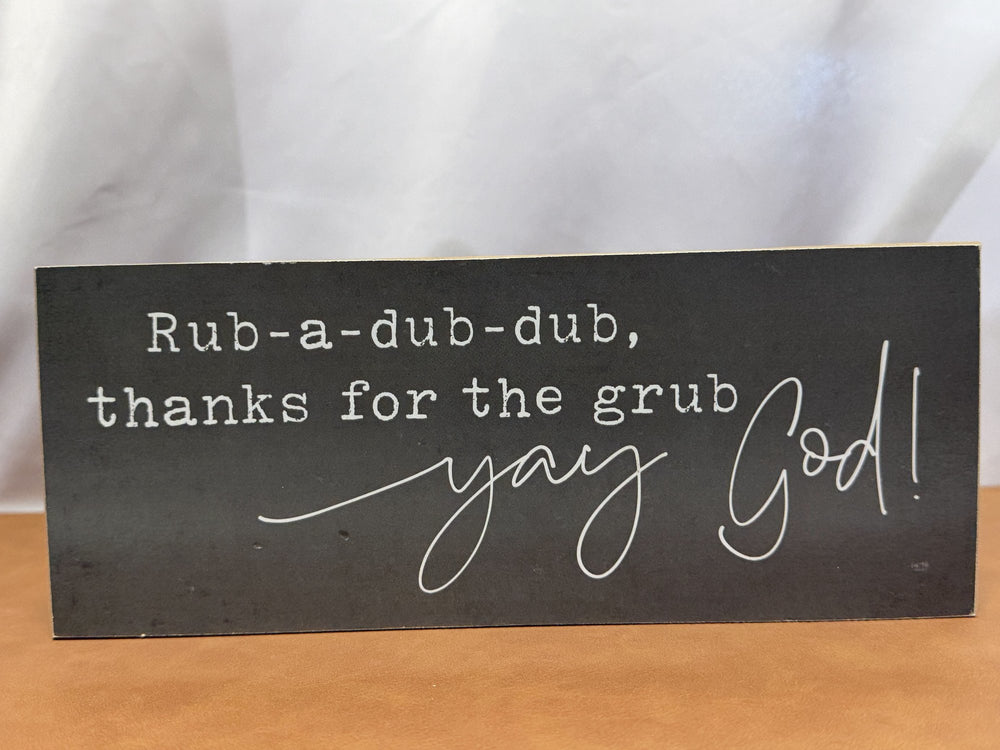 Wood sign reading a playful mealtime blessing