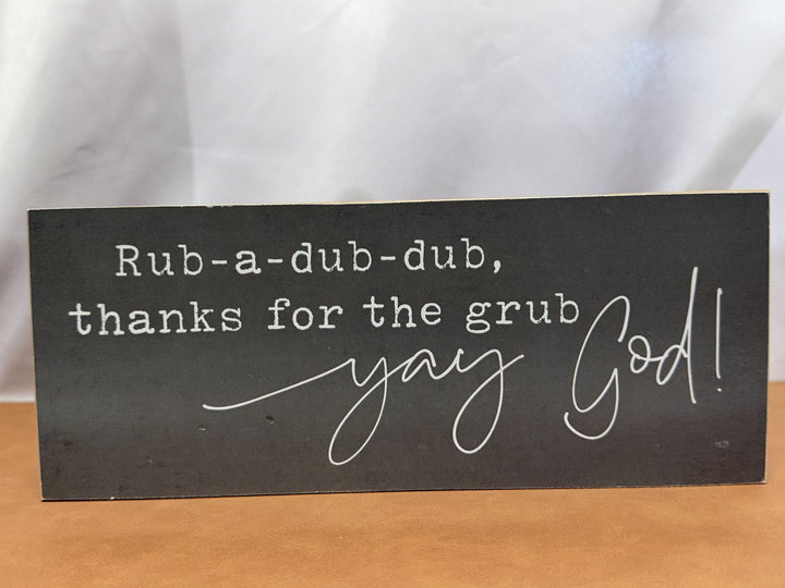 Wood sign reading a playful mealtime blessing