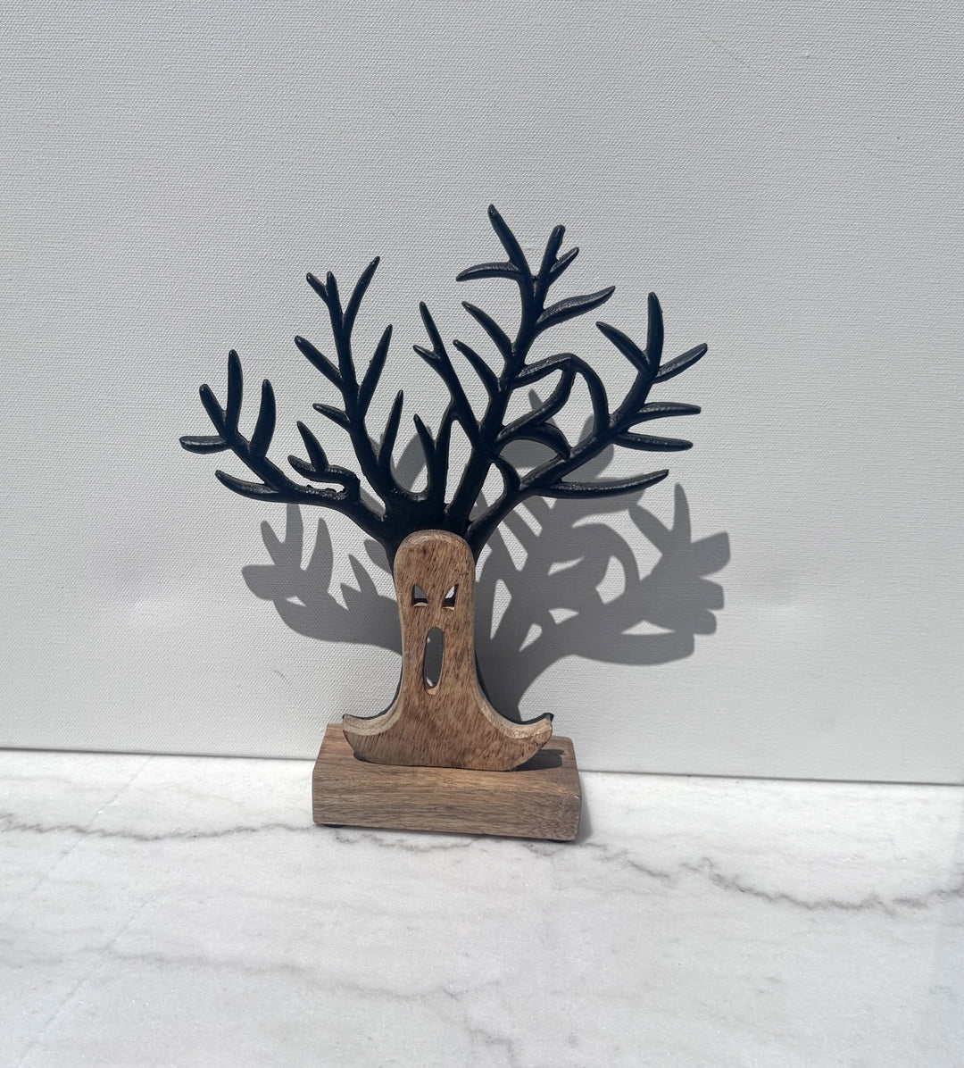 Wood and iron ghost face tree sculpture