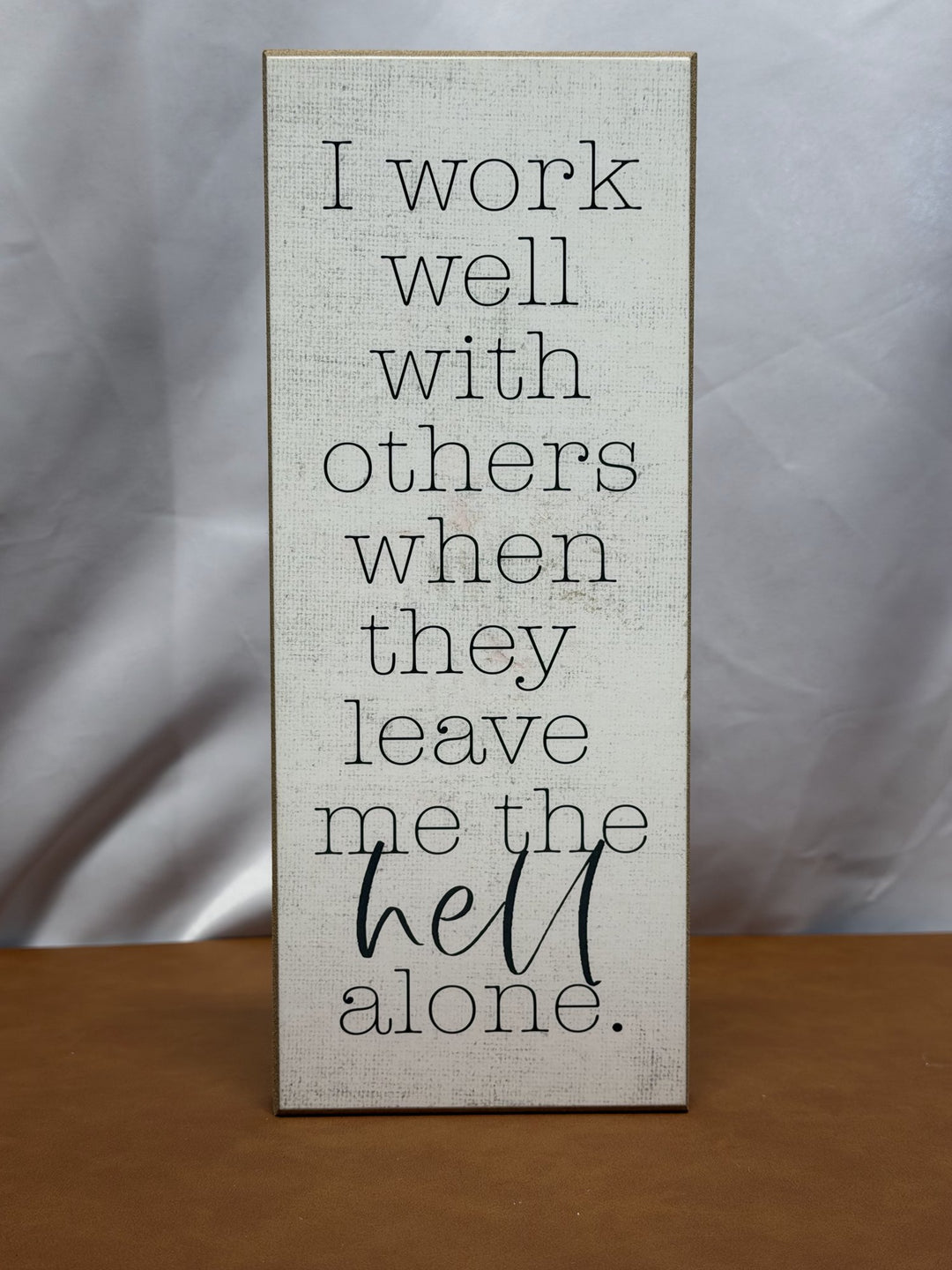 Wood sign reading I work well with others when they leave me the hell alone