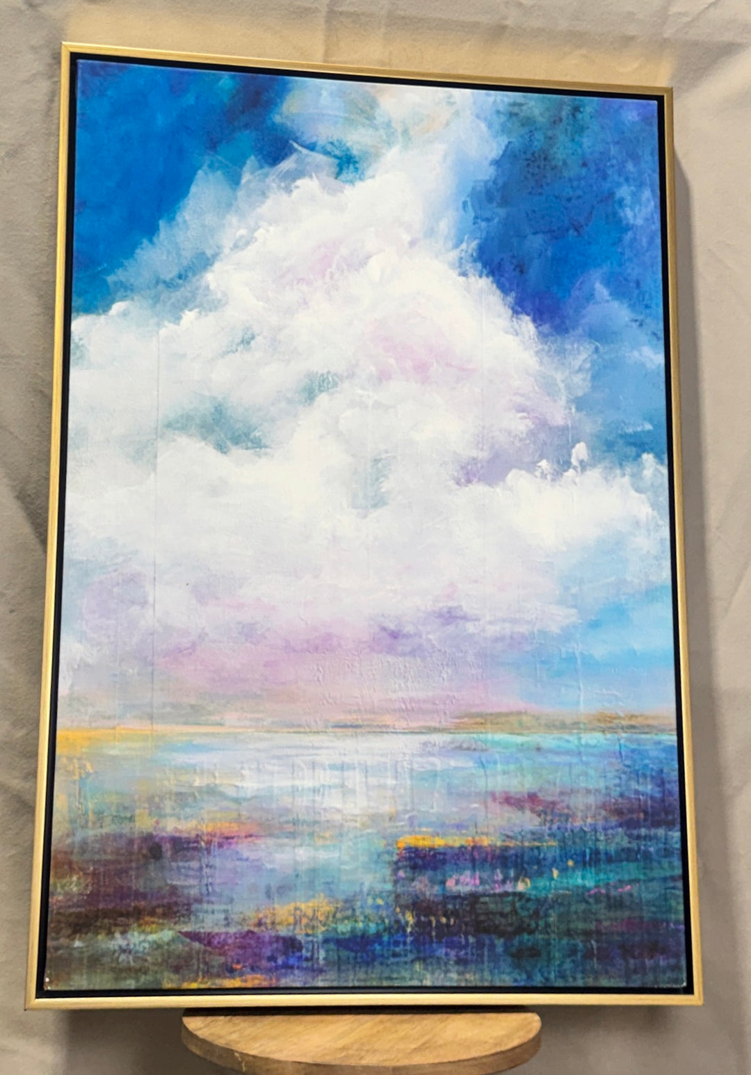 Blue, white and lavender cloudscape wall art in a slim gold frame