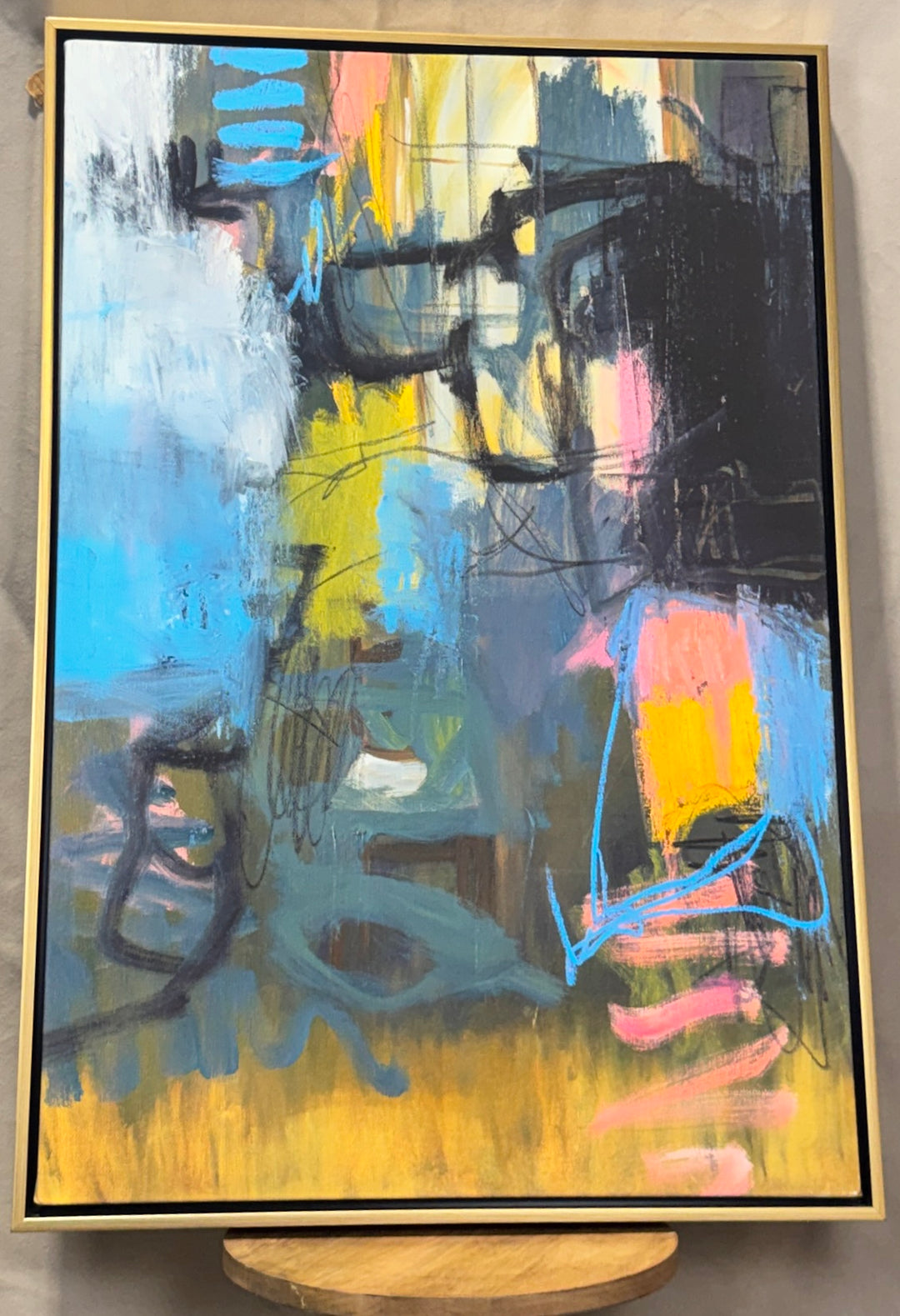 Bold blue, pink, yellow and black abstract wall art in a slim gold frame