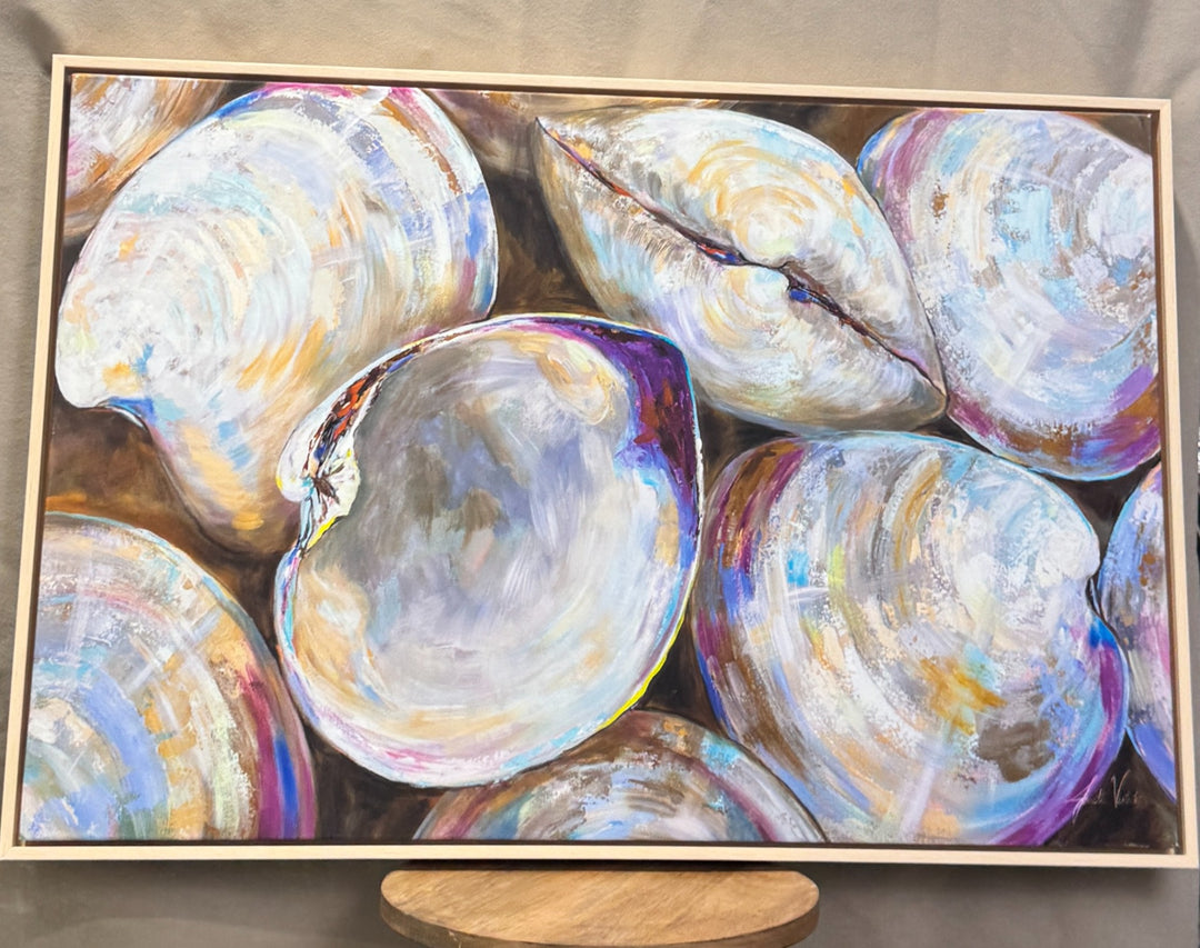Colorful oyster shell artwork in a light gold frame