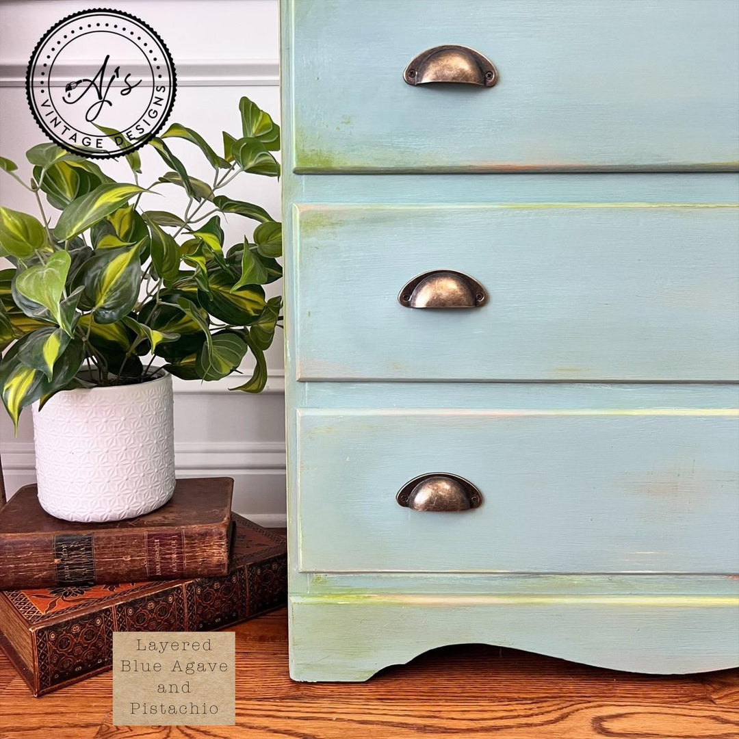 Vintage dresser in a layered Blue Agave and Pistachio finish with brass handles