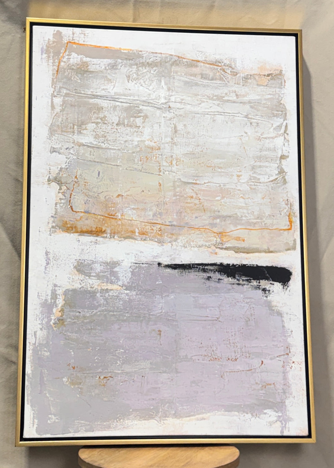 Neutral gray, cream and gold textured abstract wall art in a gold frame