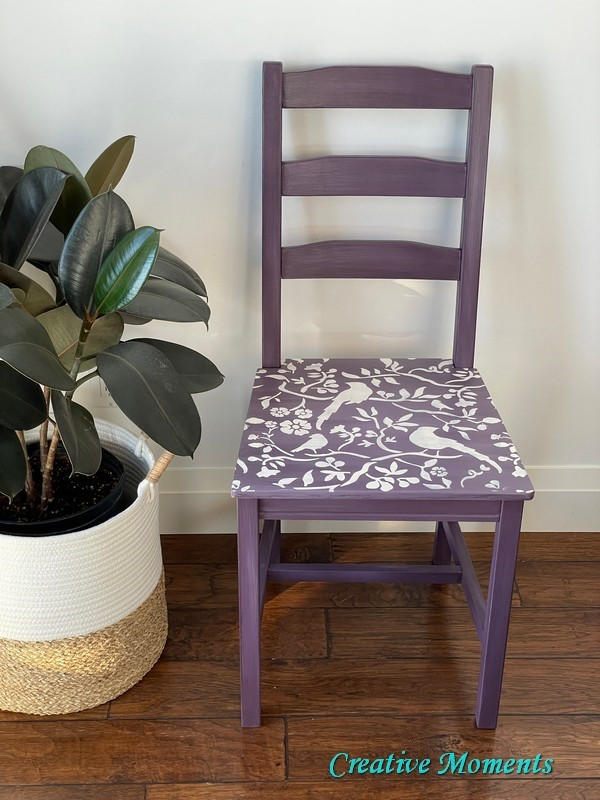 Purple clay painted chair with a white songbirds stencil
