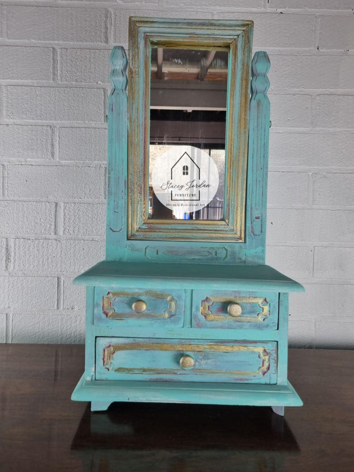 Vanity painted in Lani's Lagoon Terra Clay Paint with gold framing